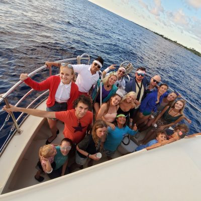 a group of people in a boat on a body of water