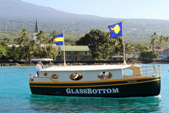 a small boat in a body of water with a mountain in the background