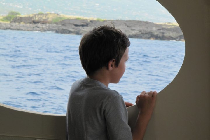 a man standing in front of a body of water