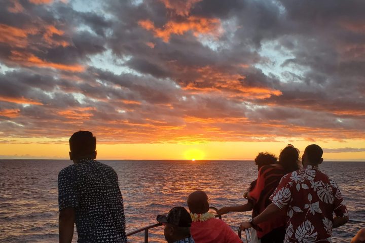 a group of people standing on a beach