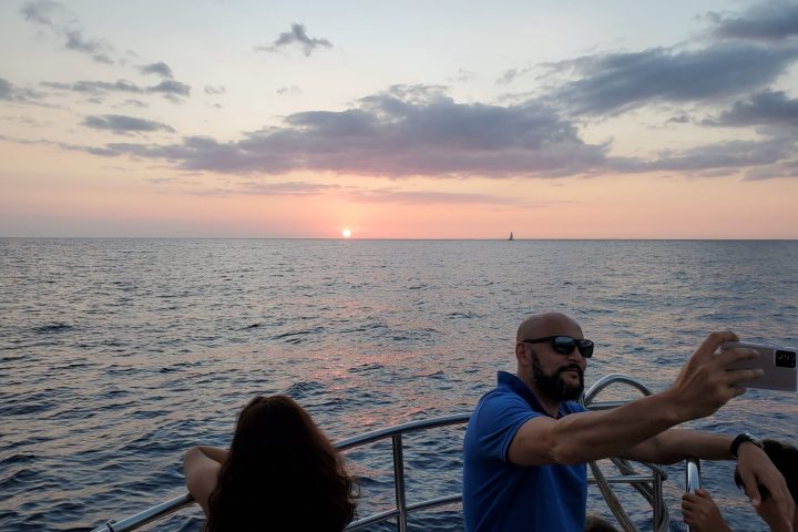 a man standing next to a body of water