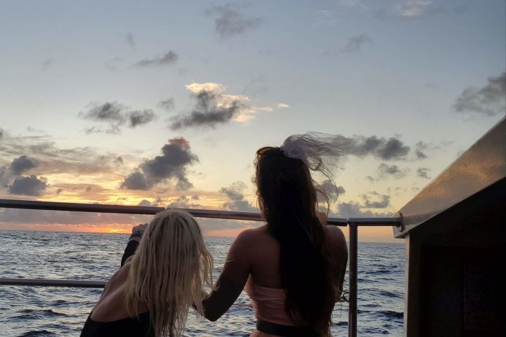 a woman standing in front of a body of water